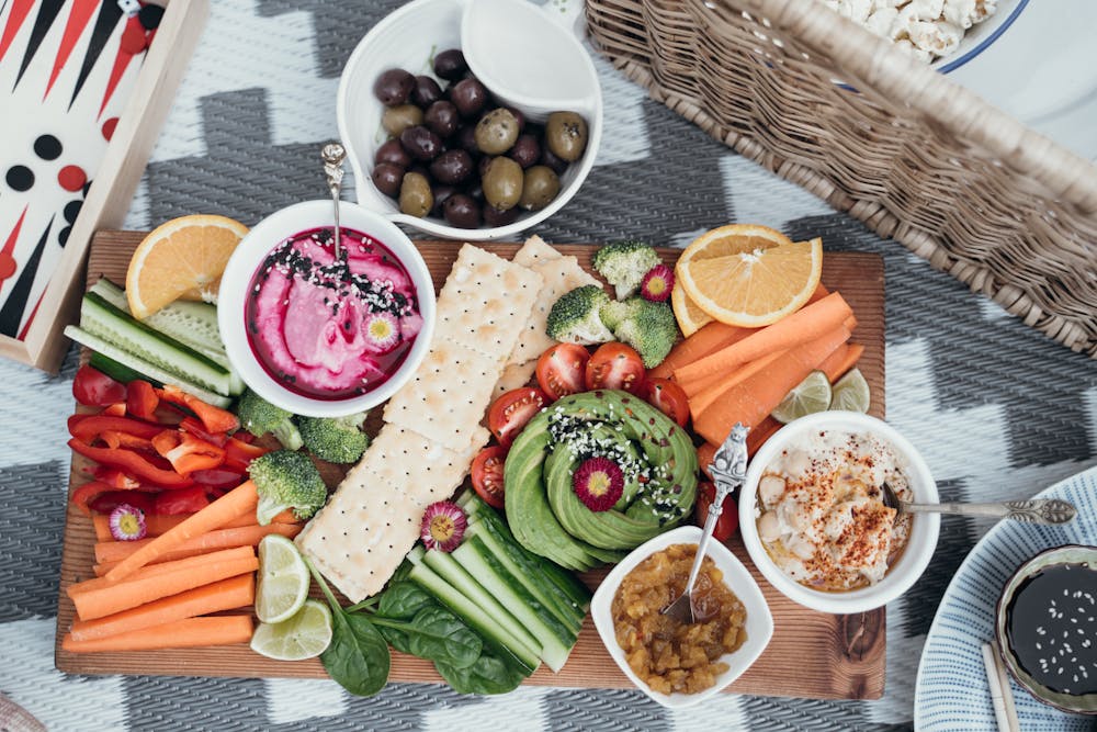 Dips and cut vegetables on a wooden board
