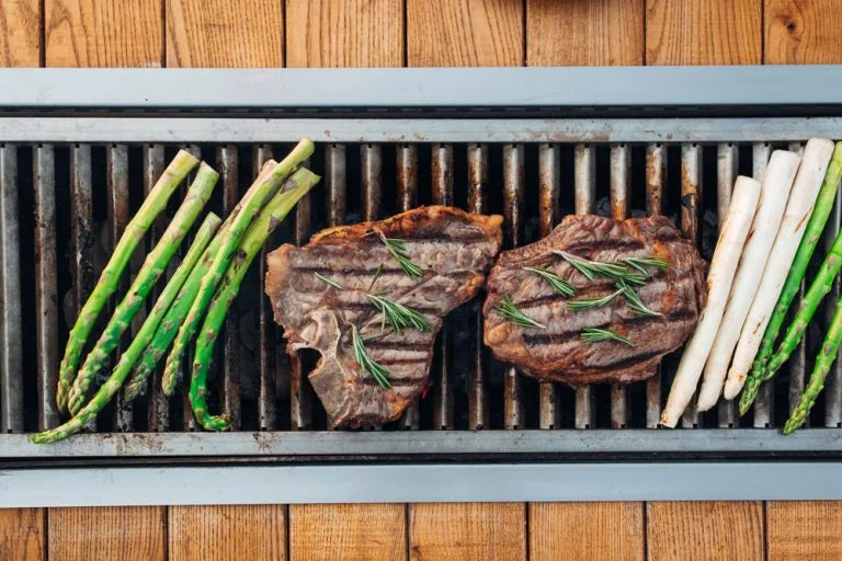 Grilling meat and vegetables on a charcoal grill