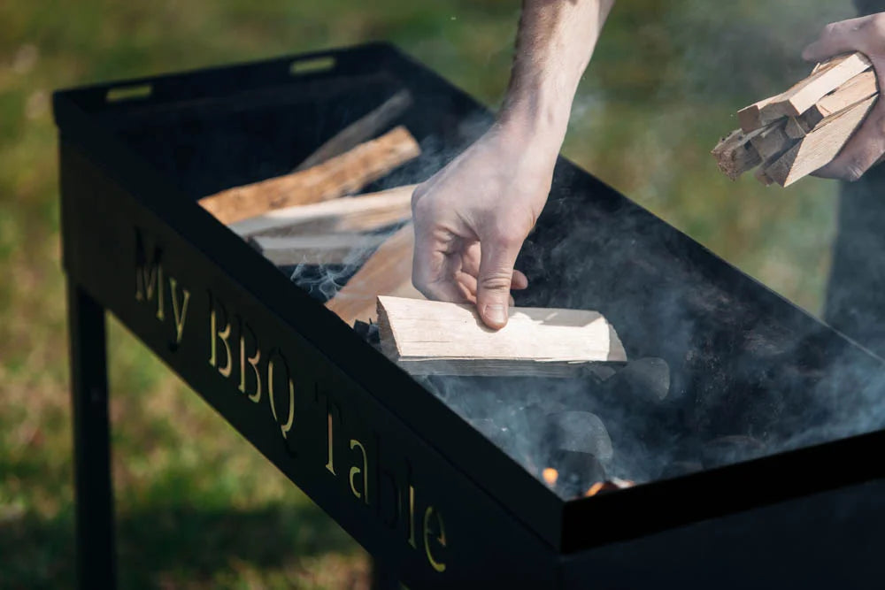 Putting wood in a charcoal grill