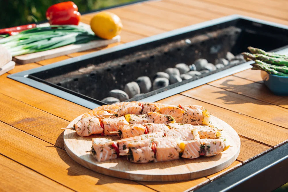 Cooking salmon on a charcoal grill table