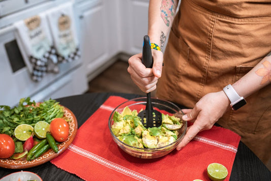 A person making guacamole