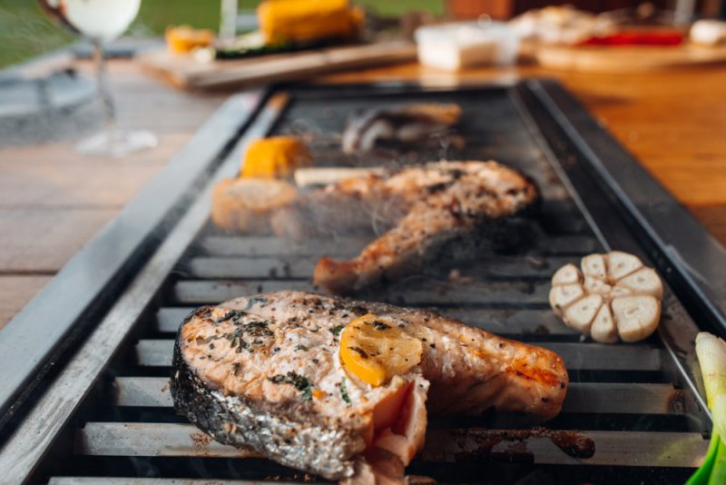 Grilling fish on a charcoal grill